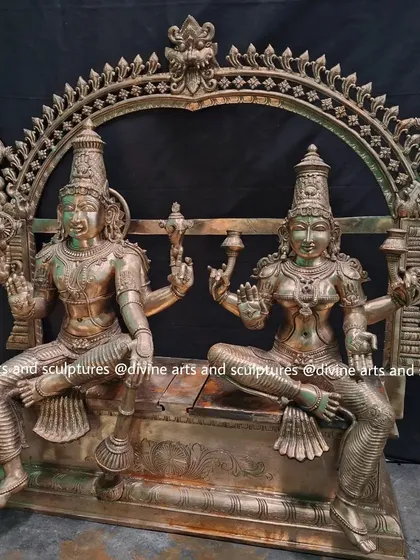 A large bronze set of Maha Vishnu and Lakshmi seated together. This type of sculpture is often commissioned for temples or large home prayer rooms.