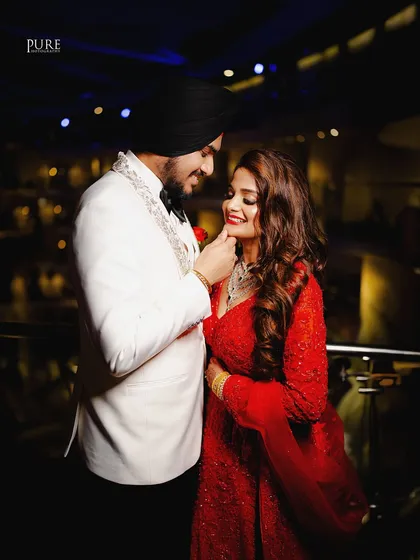 A tender moment where the groom gently touches the bride's chin. This close-up shot is full of affection and romance.