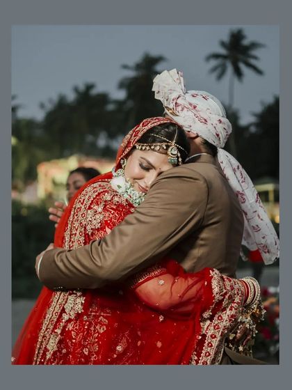 An emotional hug between the bride and a family member, a poignant and heartfelt moment from the wedding day.