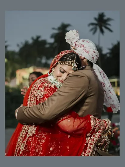 An emotional and heartfelt hug between the bride and a family member, a moment of pure love and connection.
