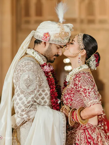A tender moment between the couple at their royal Bikaner wedding, capturing a sweet kiss on the nose.