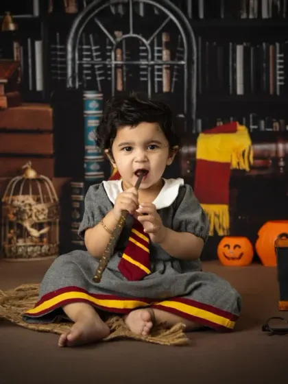 It's not just for Harry. This little girl makes a perfect Hermione Granger, captured in our Hogwarts library set for her first birthday.