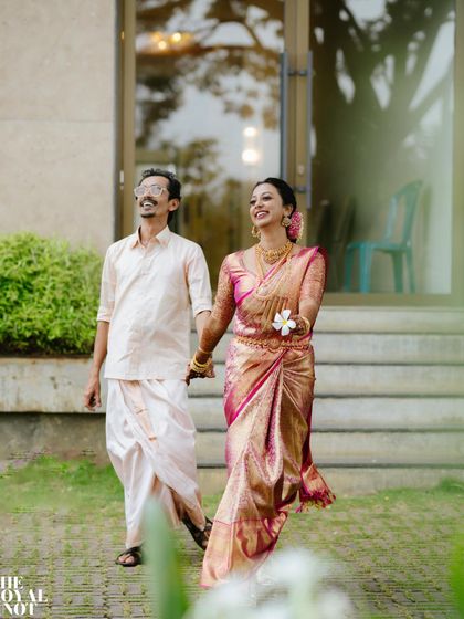 The happy couple, Rajesh and Deepthi, walking hand in hand. My focus was ensuring the groom's mundu was draped for a clean silhouette that looked great both in photos and in motion.