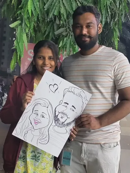 A lovely couple posing with their "Love Birds" caricature. I often add little hearts or details to make couple portraits extra special.