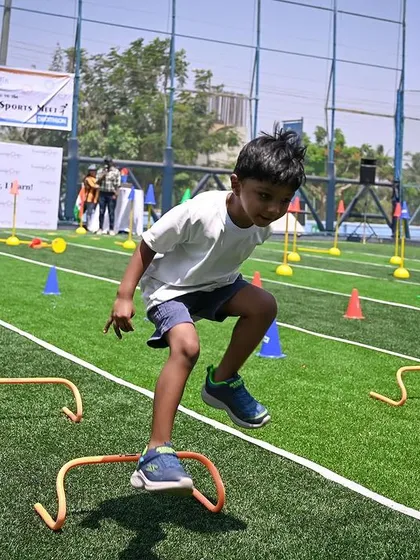 Our annual sports day is a highlight, focusing on fun, participation, and personal achievement. This young athlete is tackling the hurdle course with focus and determination, developing his gross motor skills and building confidence with every jump.