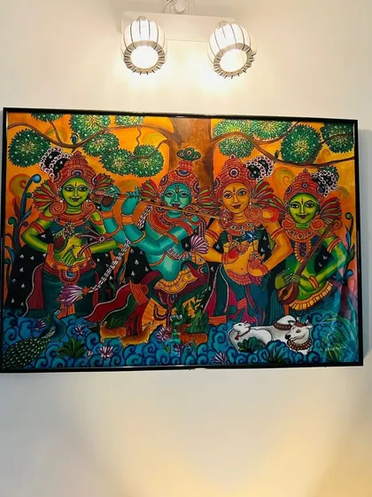 A closer look at the painting in its new home, with the wall lights highlighting its vibrant colors.
