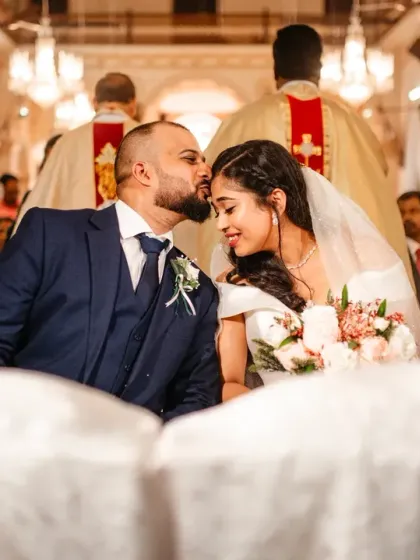 A tender kiss on the forehead during the church ceremony. These quiet, affectionate moments between the couple are what make the day so special.