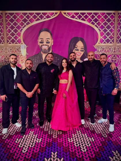 The DJ team with the happy couple at their Sangeet in Marrakech. The custom backdrop with their caricatures was a lit touch.