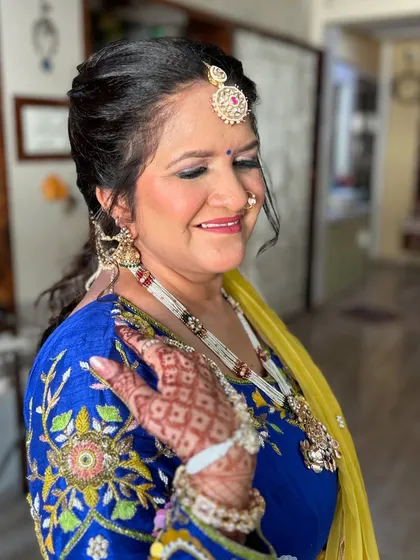 A close-up showing her beautiful smile and the intricate details of her jewelry.