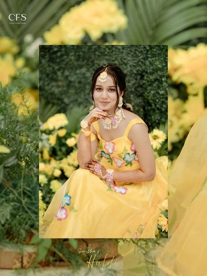 A beautiful portrait of the bride amidst a sea of yellow flowers at her Haldi ceremony. This shot captures the vibrant colors and her radiant happiness.