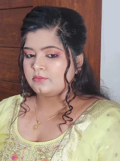 From another angle, you can see how the soft curls and half-up hairstyle frame her face. I always include hairstyling to ensure your entire look is cohesive and polished.