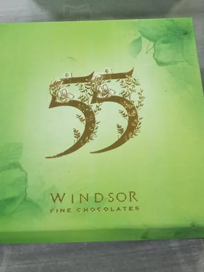 Celebrating a special milestone? I designed this elegant emerald-themed gift box for a 55th birthday. I work with you to create custom packaging and chocolate assortments that perfectly match the theme and sentiment of your celebration.