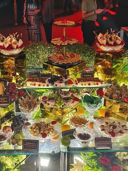 A sprawling winter-themed grazing table, featuring an extensive selection of cheeses, crackers, fruits, and dips. It's a visual spectacle and a delight for the senses.