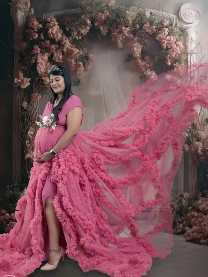 The flowing pink gown creates a stunning visual effect in this artistic shot, with the train beautifully arranged to look like it's flying.