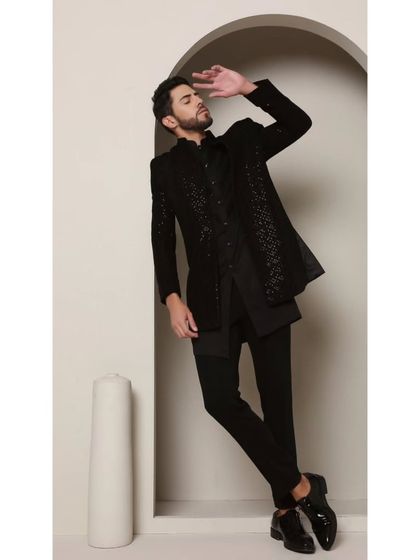 A powerful stance in the 'Celestial' Shrug Set. This all-black ensemble with its embroidered shrug is designed for the man who isn't afraid to push fashion boundaries.