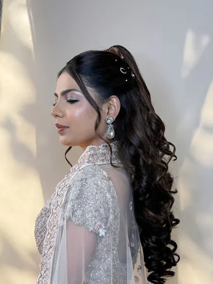 A side profile of the sangeet look, showcasing the sharp wing eyeliner and the voluminous high ponytail.