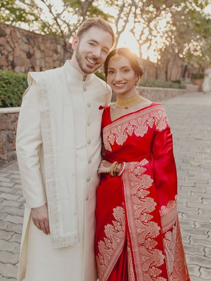 A heartwarming moment between the bride and groom. Her radiant makeup looks beautiful in the golden hour light, creating a memory to last a lifetime.