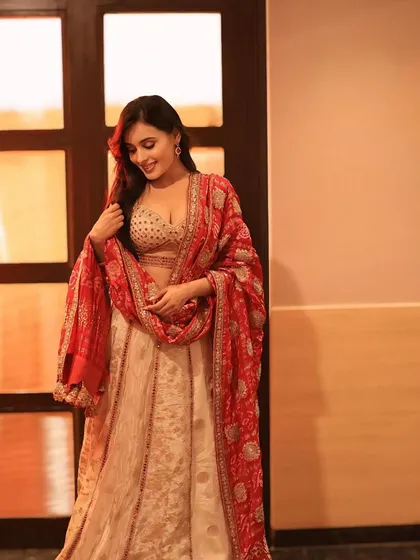 This candid shot from the photoshoot captures a natural smile, with makeup that looks fresh and radiant.