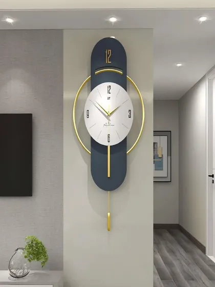 A modern marvel, this imported pendulum wall clock features a sleek, elongated design in navy and gold. The minimalist white clock face is perfectly balanced within a golden ring, creating a piece of functional art for a contemporary space.