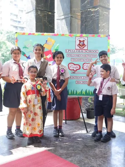 A group of proud participants and winners from the 'Carpe Diem' literary event pose with their teacher. We celebrate every student's effort and achievement.
