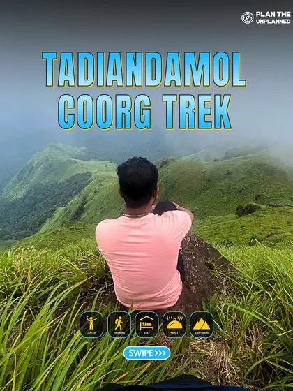 A trekker sits on a rock, enjoying the view from Tadiandamol, Coorg's highest peak.