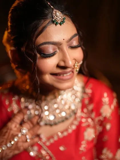 A close-up of the bride's shimmery eye makeup and happy expression.