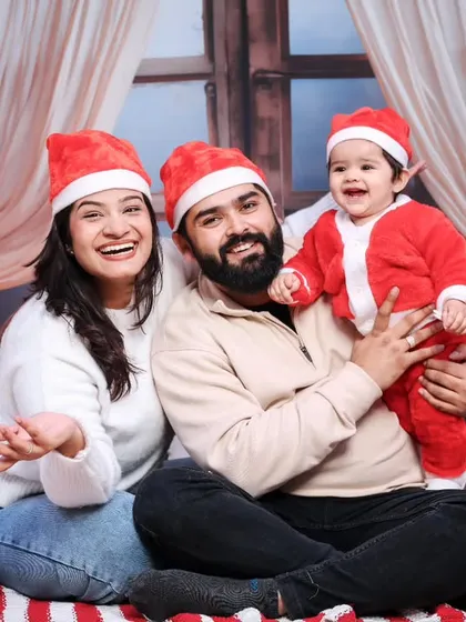 A laughing, happy family enjoying their Christmas-themed photoshoot in our studio.