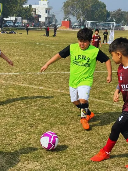 Teamwork in action. Our players work together to move the ball up the field during a competitive tournament game.