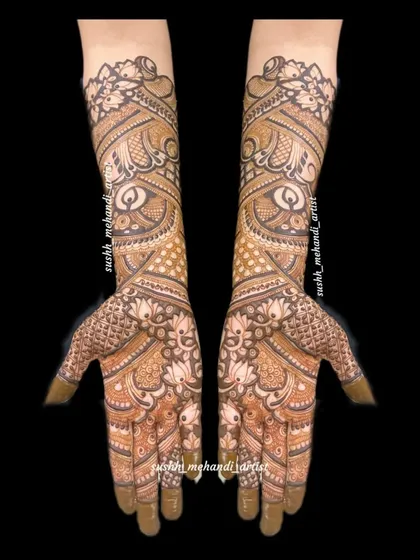 An elegant full-hand design with a focus on flowing, paisley-inspired patterns. The details extend all the way to the elbows.