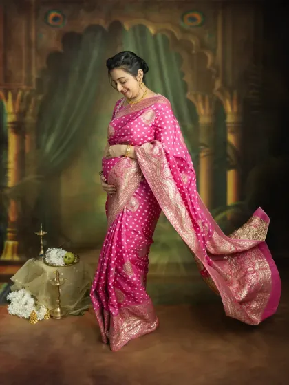 The grace of a mother-to-be in a flowing pink saree. This full-length portrait captures the elegance and beauty of pregnancy, creating a timeless piece of art you'll treasure forever.