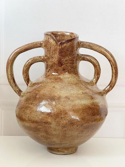 A full view of the multi-handle vase, showcasing its beautiful, rounded form and the unique shape of the handles.