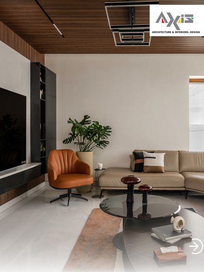 A closer look at the balance of form and function. The sleek, wall-mounted media unit keeps the space uncluttered, while the combination of a leather armchair and plush sofa offers varied seating options.