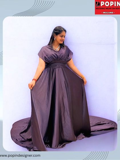 A beautifully edited shot of the purple satin gown, highlighting its silky texture and dramatic trail. This is the definition of red-carpet elegance, available for rent.