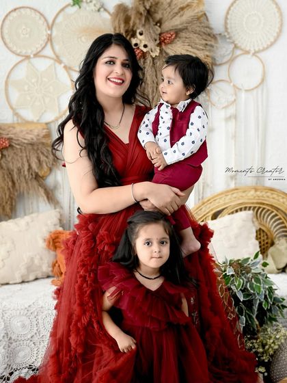A mother's embrace with her two children. The coordinated outfits and the genuine smiles make this a heartwarming portrait of sibling and motherly love.