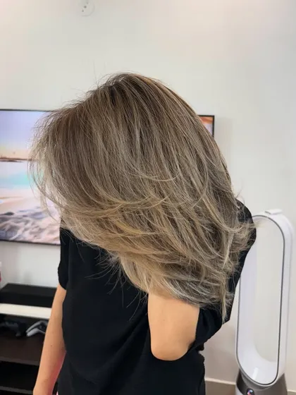 This photo shows the beautiful layers and buttery blonde tones in a different light. The style is voluminous and full of movement.