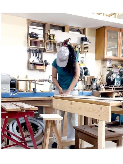 A student fully focused on her work at the bench. The workshop is a place to disconnect from distractions and connect with the craft.