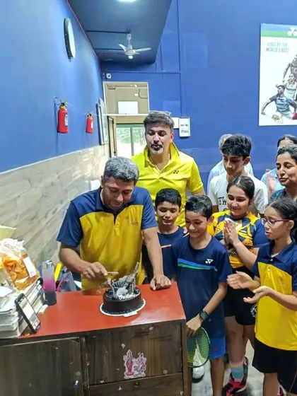 Coach Prafull Sir cutting his birthday cake, surrounded by his enthusiastic students at the Willingdon Catholic Gymkhana centre.