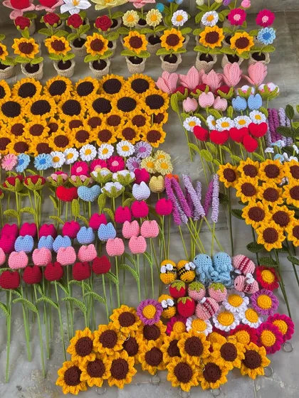 Another angle of the floor filled with handmade flower stems, ready for packing.