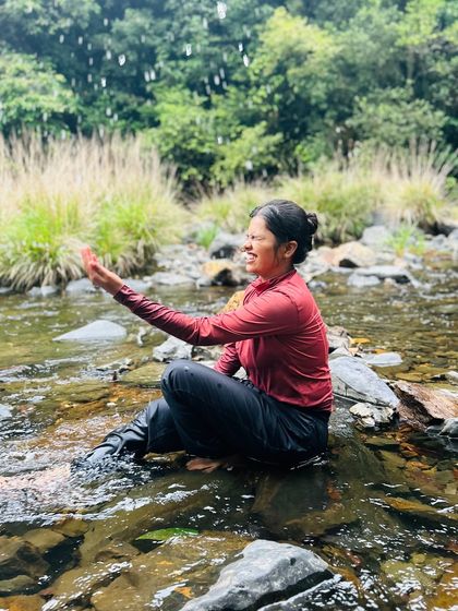 A trekker enjoying the cool waters of a stream during the Kurinjal trek. It's the perfect way to cool down and connect with nature.