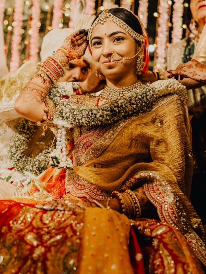 A playful, candid moment during the wedding rituals. The bride's shy smile is just perfect.