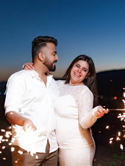 Lighting up the night with sparklers. This is a fun and magical way to end a pre-wedding shoot, creating joyful and celebratory images against the twilight sky.