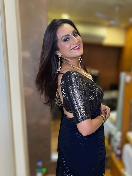 A side profile showing her beautiful smile and the flawless makeup that completes her party-ready look.