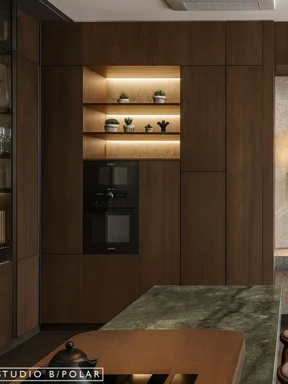 We integrated the oven and microwave into a tall unit, creating a clean, streamlined look. The open shelving with backlighting provides a beautiful display for crockery and adds ambient light.