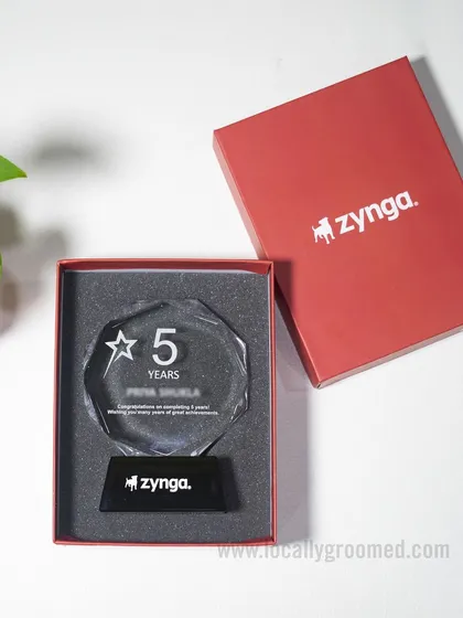 We celebrate milestones with elegance and precision. This custom-designed crystal trophy for Zynga commemorates a 5-year work anniversary, featuring their logo etched on the base and presented in a branded protective box.