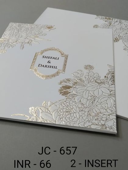 This minimalist white card is elevated by a beautiful gold foil floral pattern. It's a modern and chic design that is both simple and luxurious.