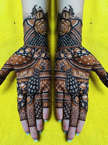 A beautiful floral design with peacock accents. This kind of intricate, full-hand design is perfect for any festive occasion.