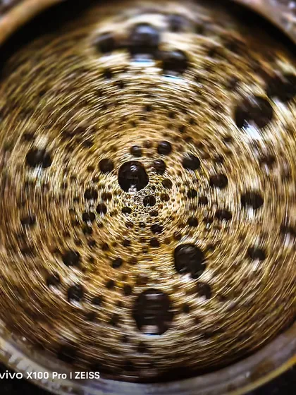 A creative macro shot of coffee bubbles, taken with a vivo X100 Pro. This shows my ability to create abstract and artistic images for brand collaborations.