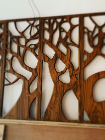 A duplicate of image 61, this photo shows the beautiful grain and finish of the wood used for the CNC-cut tree mural, a testament to our love for natural materials.