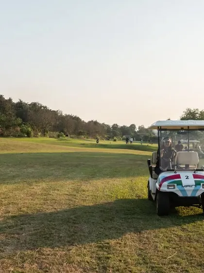 A golf cart parked on the course, ready for the next hole. It highlights the convenience we offer for navigating the greens while enjoying the wide-open spaces.