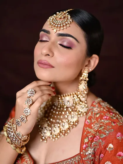 A detailed close-up of the eye makeup. The blended pink and mauve tones create a soft, romantic effect that is perfect for bridal or festive occasions.